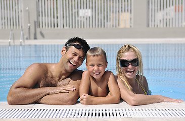 Image showing happy young family have fun on swimming pool