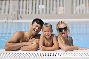 Image showing happy young family have fun on swimming pool 