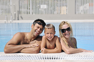 Image showing happy young family have fun on swimming pool