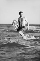 Image showing Portrait of a young  kitsurf  man at beach on sunset