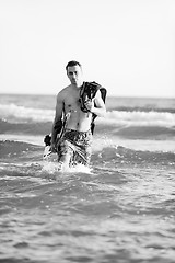 Image showing Portrait of a young  kitsurf  man at beach on sunset