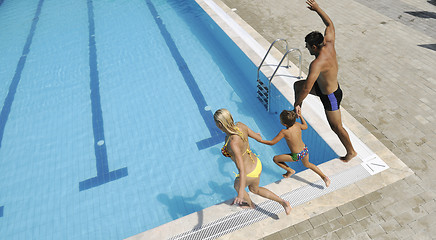 Image showing happy young family have fun on swimming pool