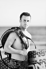 Image showing Portrait of a young  kitsurf  man at beach on sunset