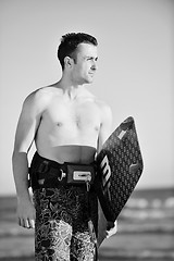 Image showing Portrait of a young  kitsurf  man at beach on sunset