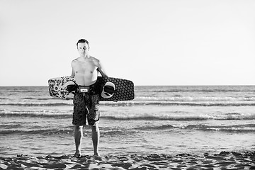 Image showing Portrait of a young  kitsurf  man at beach on sunset