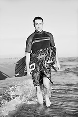 Image showing Portrait of a young  kitsurf  man at beach on sunset