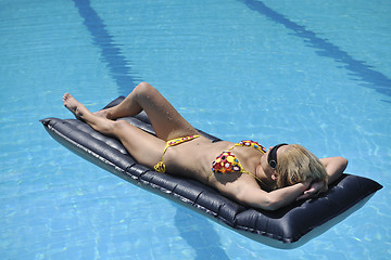 Image showing beautiful woman relax on swimming pool