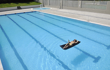 Image showing beautiful woman relax on swimming pool