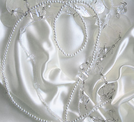 Image showing White pearls and nacreous beeds on white silk 