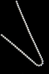 Image showing White pearls on the black velvet  