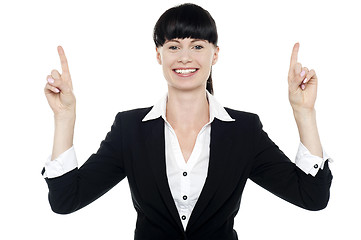Image showing Smiling woman posing with raised fingers