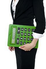 Image showing Cropped image of a woman holding big calculator