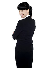 Image showing Young corporate lady turning back and smiling