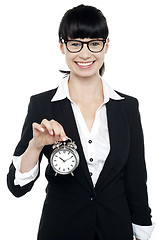 Image showing Smiling young lady holding old fashioned time piece