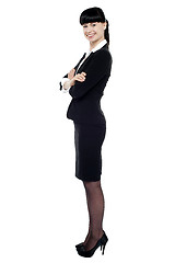 Image showing Cheerful confident business lady posing with arms crossed