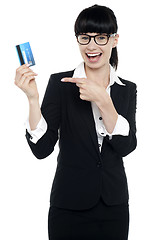 Image showing Businesswoman in glasses pointing at credit card