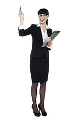 Image showing Cheerful businesswoman posing with raised arm