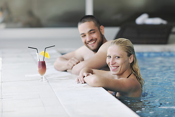 Image showing happy cople relaxing  at swimming pool