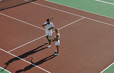 Image showing happy young couple play tennis game outdoor