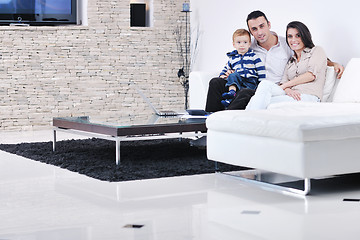 Image showing happy young family have fun  with tv in backgrund