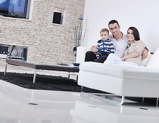 Image showing happy young family have fun  with tv in backgrund