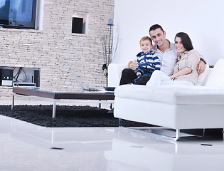 Image showing happy young family have fun  with tv in backgrund