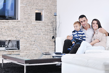 Image showing happy young family have fun  with tv in backgrund