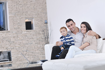 Image showing happy young family have fun  with tv in backgrund