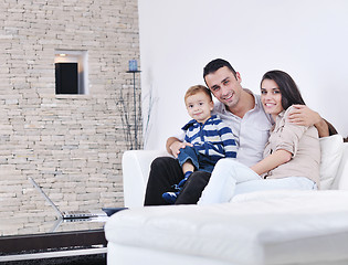 Image showing happy young family have fun  with tv in backgrund