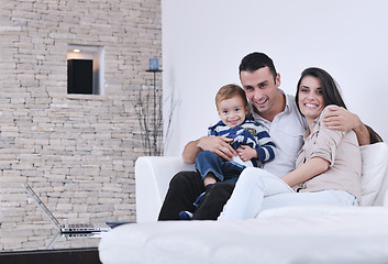 Image showing happy young family have fun  with tv in backgrund