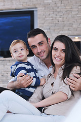 Image showing happy young family have fun  with tv in backgrund