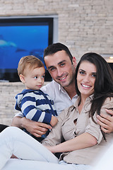 Image showing happy young family have fun  with tv in backgrund