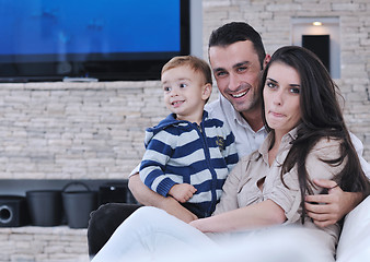 Image showing happy young family have fun  with tv in backgrund