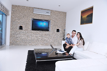 Image showing happy young family have fun  with tv in backgrund