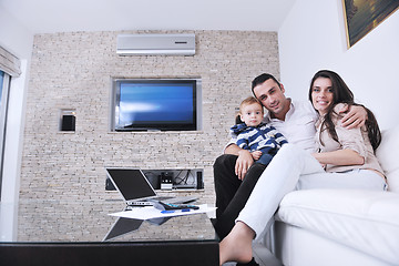 Image showing happy young family have fun  with tv in backgrund