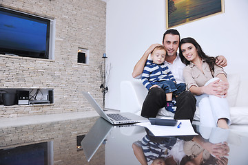 Image showing happy young family have fun  with tv in backgrund