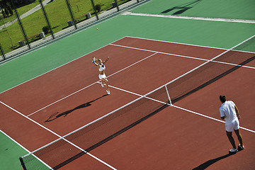 Image showing happy young couple play tennis game outdoor