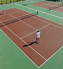 Image showing happy young couple play tennis game outdoor