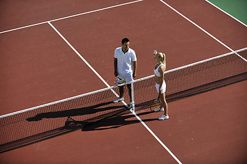 Image showing happy young couple play tennis game outdoor