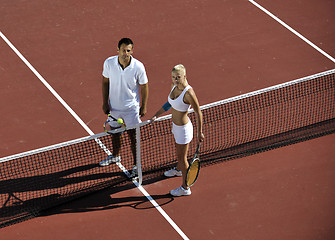 Image showing happy young couple play tennis game outdoor