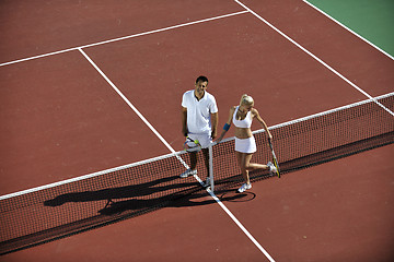 Image showing happy young couple play tennis game outdoor