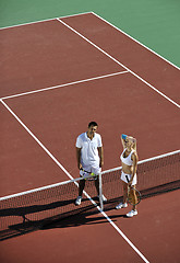 Image showing happy young couple play tennis game outdoor