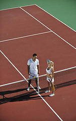 Image showing happy young couple play tennis game outdoor