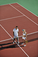 Image showing happy young couple play tennis game outdoor