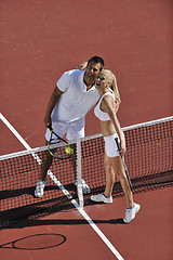 Image showing happy young couple play tennis game outdoor