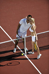 Image showing happy young couple play tennis game outdoor