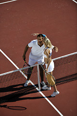 Image showing happy young couple play tennis game outdoor