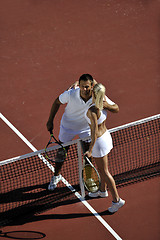 Image showing happy young couple play tennis game outdoor