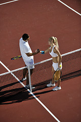 Image showing happy young couple play tennis game outdoor