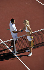 Image showing happy young couple play tennis game outdoor